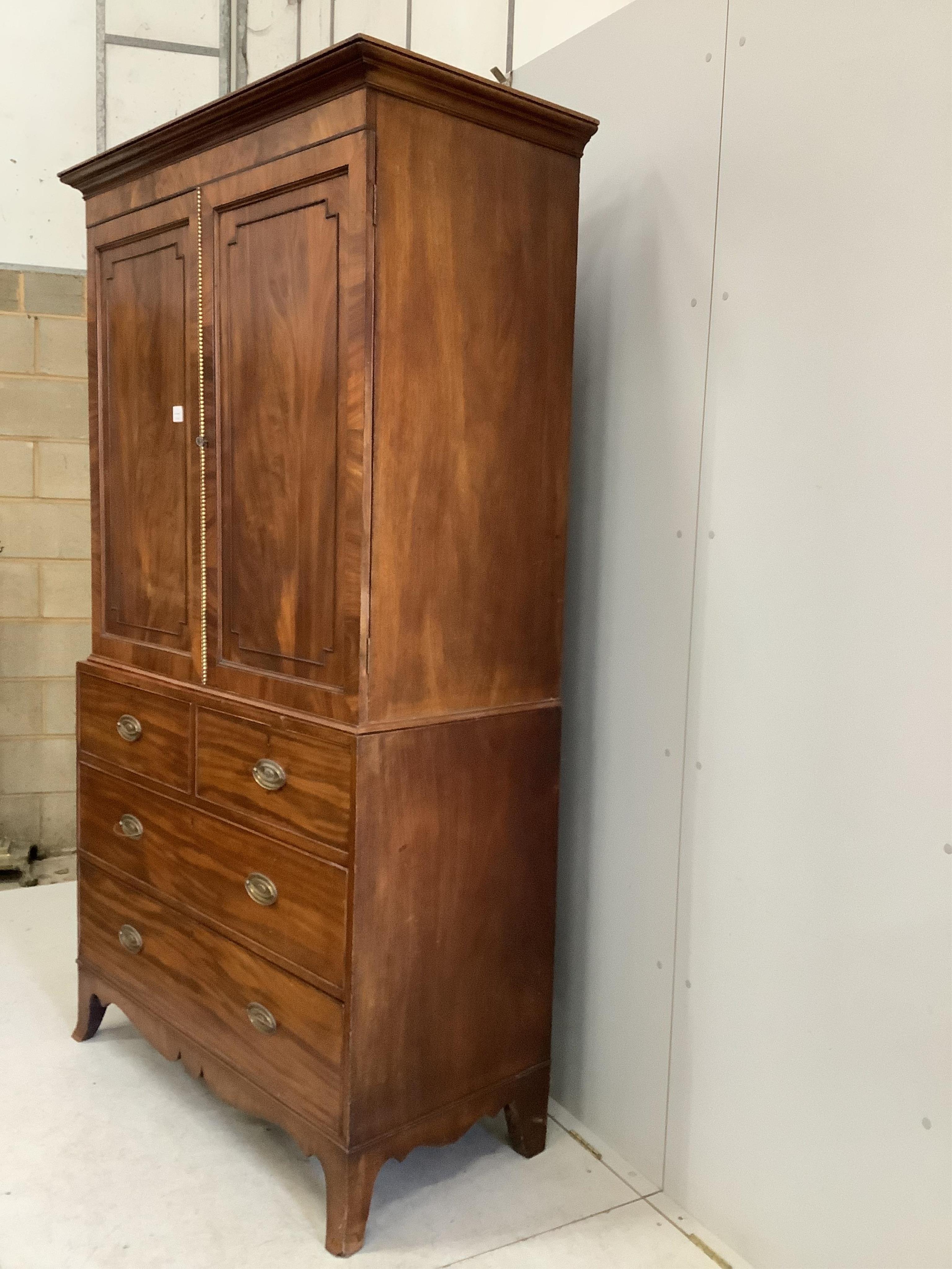 A Regency mahogany linen press, width 120cm, depth 56cm, height 211cm. Condition - fair, interior shelves are later